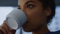 African woman drinking coffee cup in office. Professional enjoying coffee Royalty Free Stock Photo