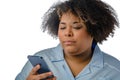 closeup, Afro-Latina medical woman of Venezuelan ethnicity reading using her phone, white background Royalty Free Stock Photo