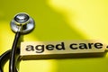 Closeup aged care with stethoscope concept inspiration on yellow background