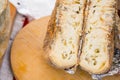 Closeup aged soft cheese on a served on wooden background. Dairy delicacies.