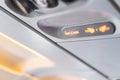 Closeup airplane Console panel; lamp, light, need help button, air condition, sefty belt and no smoking lighting sign Royalty Free Stock Photo