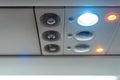 Closeup airplane Console panel; lamp, light, need help button, air condition, sefty belt and no smoking lighting sign Royalty Free Stock Photo