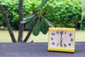 Closeup alarm yellow clock, 6 o`clock with Natural bokeh background