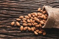 Closeup almonds on wooden texture on dark background