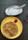 Aloo Paratha Indian Potato stuffed Flatbread. Served with fresh curd and tomato ketchup