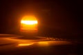 Closeup of an amber strobe warning light on the roof of a car at night