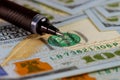 Closeup American dollars banknotes with ballpoint pen