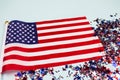 Closeup of american flag and star shaped sparkles on light blue background with copyspace. National symbolic of USA - flag Old