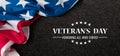 Closeup of American flag with Text Veterans Day Honoring All Who Served on black textured background. Royalty Free Stock Photo