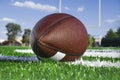 Closeup of American football on field with goal post Royalty Free Stock Photo