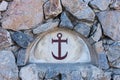 Closeup anchor mosaic tiles on an stone wall