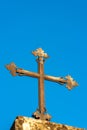 Christian cross in wrought iron on a clear blue sky - Religious symbol Royalty Free Stock Photo