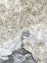 Closeup of ancient wall with plaster falling of the stone structure. Royalty Free Stock Photo
