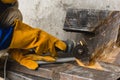 Closeup of a angle grinder being used to cut a notch inside a steel pipe. At a construction site