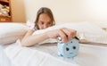 Closeup of annoyed girl reaching for alarm clock