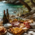 Closeup Antipasto platter with prosciutto crudo or jamon, salami, olives and white wine on a wooden board on the background of the