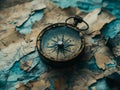 closeup of antique compass on rugged blue map surface Royalty Free Stock Photo