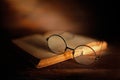 Antique glasses with old book