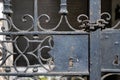 Closeup of an antique metal gate with a dirty key lock under the sunlight Royalty Free Stock Photo