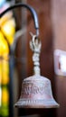 Closeup of antique rusty bell on stucco wall Royalty Free Stock Photo