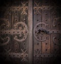 Closeup of antique vinage wooden door with an iron handle decorated with iron pattern Royalty Free Stock Photo