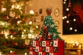 Closeup of a three-dimensional Advent Calendar in front of Christmassy decorated Background