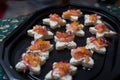 appetizers toast with salmon and lumpfish roe in a black plate
