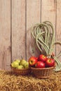 Closeup apples and pears in basket on hay bale