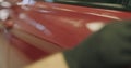 Closeup applying ceramic coating on the red car