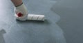 Closeup applying protective coating on the concrete floor Royalty Free Stock Photo