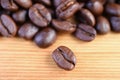 Closeup an Arabica Roasted Coffee Bean with Coffee Beans Pile in the Backdrop Royalty Free Stock Photo