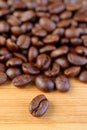 Closeup an Arabica Roasted Coffee Bean with Blurry Coffee Beans Pile in Background Royalty Free Stock Photo