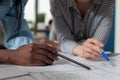 Closeup of architectural engineer hands holding pencil and pen over blueprints Royalty Free Stock Photo