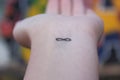 Closeup of the arm with an infinity symbol tattooed in his wrist. infinity sign on the hand. endless love concept Royalty Free Stock Photo