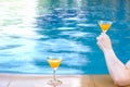 closeup arm of woman drinking beverage in poolside, happy life on summer Royalty Free Stock Photo