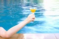 closeup arm of woman drinking beverage in poolside, happy life on summer Royalty Free Stock Photo