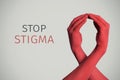 Red awareness ribbon and text stop stigma