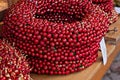 Artificial wreath with red berries on counter during Christmas market