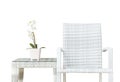 Closeup artificial plant with white orchid flower on pink flower pot on wood weave table with wood weave chair isolated on white