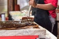 Artisan chocolate worker mixing melting chocolate with spatulas on a table