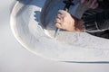 Closeup of an artist carving curves into a white stone Royalty Free Stock Photo