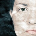 Closeup Artistic Portrait of Woman and with Smoke Superimposed Over Her Face