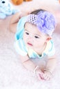 Closeup asian baby infant laying comfortably on bed playing with bear doll on softness cushion,Baby development concept