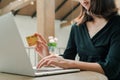 Closeup Asian beautiful woman Wearing a black shirt Sitting in the house Have a credit card in hand Is buying online products with Royalty Free Stock Photo