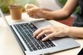 Closeup of Asian businesswoman typing on computer while holding credit card, Female shopping online or booking ticket Royalty Free Stock Photo