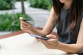 Closeup of Asian businesswoman using mobile phone while holding credit card, Female shopping online or booking ticket. Business, Royalty Free Stock Photo