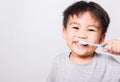 Closeup Asian face, Little children boy hand holds toothbrush he brushing teeth myself