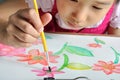 Closeup asian girl hand paint with her watercolor picture