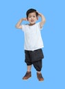 Closeup asian kid do not look satisfied with something isolated on blue background Royalty Free Stock Photo