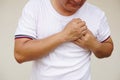 Closeup Asian man feels hurt his chest, suffering from chest pain. C